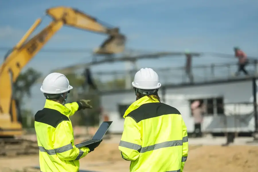 Supervisor pointing out site progress to his team