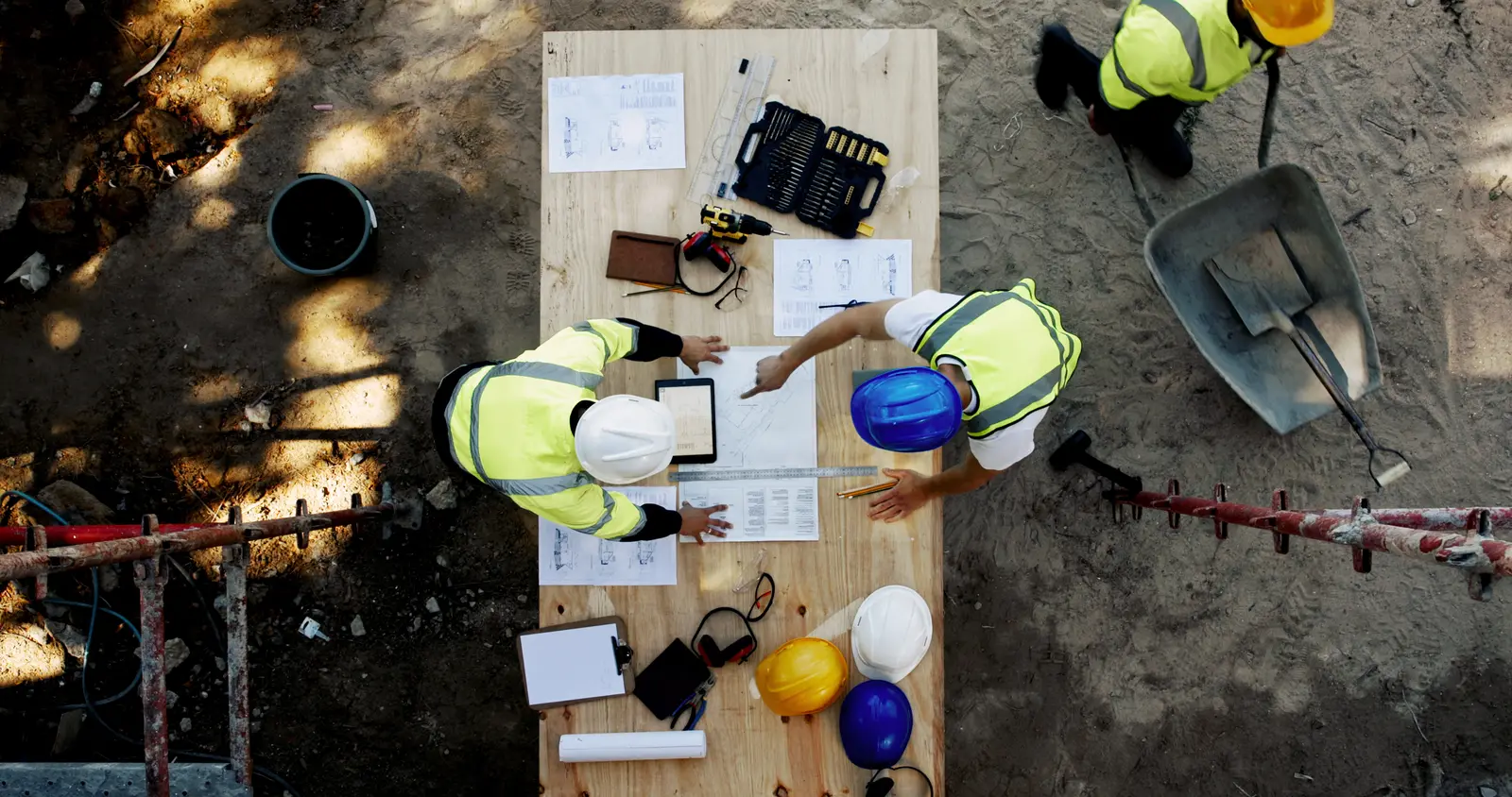 Supervisors reviewing drawings and budget on site